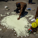 In Chicago, Rickey Turner presses his hand in paint that his family used to cover the blood of his brother, Tony Haywood, on July 18, in the parking lot where Haywood was shot and killed the night before. The Chicago Tribune’s Brian Cassella has been writing a series called “Second Take,” meant to show what happens the day after gun violence hits another piece of Chicago. Sometimes, he said, “people get to know their neighbors a little better.” (Brian Cassella/Chicago Tribune)